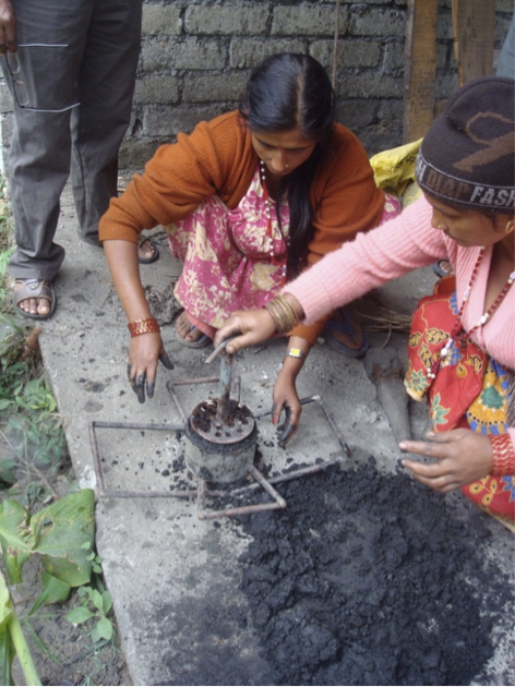 Women making bio-briquettes from forest weed –banmara. These can be used as an alternate to fuel for cooking and heating purposes. This also has market demand.